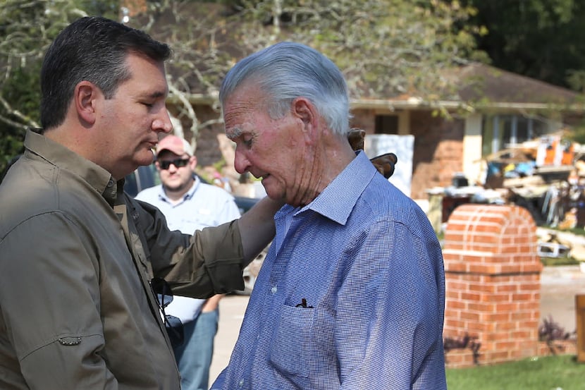 Sen. Ted Cruz comforts longtime Dickinson resident Travis Moss as he becomes emotional after...