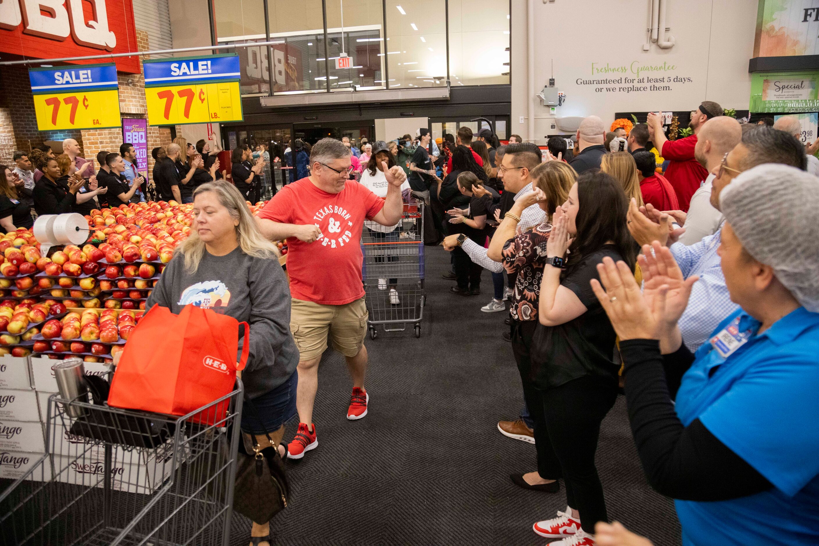 Employees greet customers during the grand opening of the H-E-B store in Allen on Wednesday,...