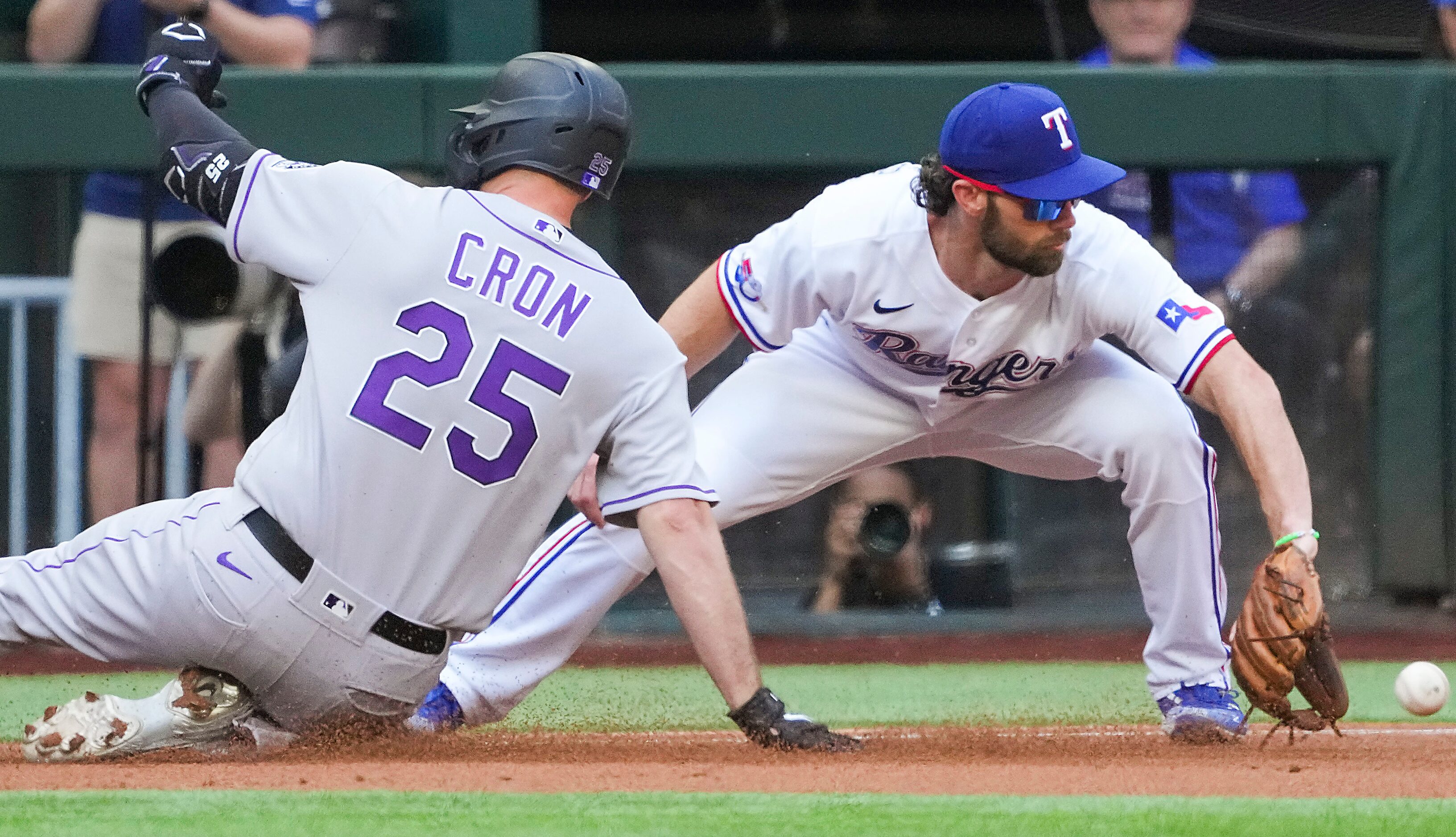 Colorado Rockies first baseman C.J. Cron is safe at third base with a triple ahead of the...