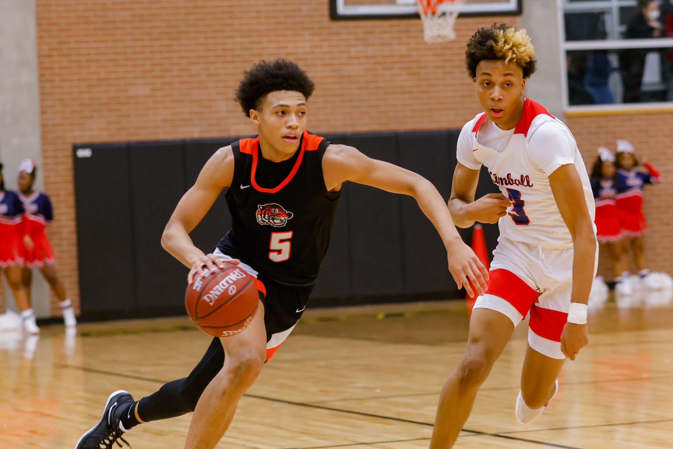 Lancaster's Elijah Hughey (5) drives past Kimball's Jayden Blair (0) during the first half...