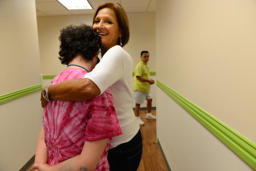 Volunteer Kathy Wright hugs a student in her health and fitness class at My Possibilities.