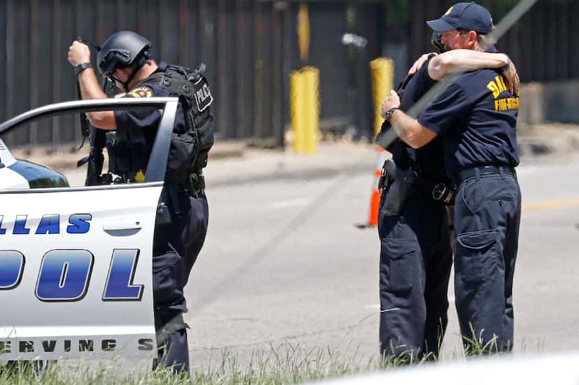 William Bruce (right) embraces son Chase near the scene of Monday's fatal shooting that left...