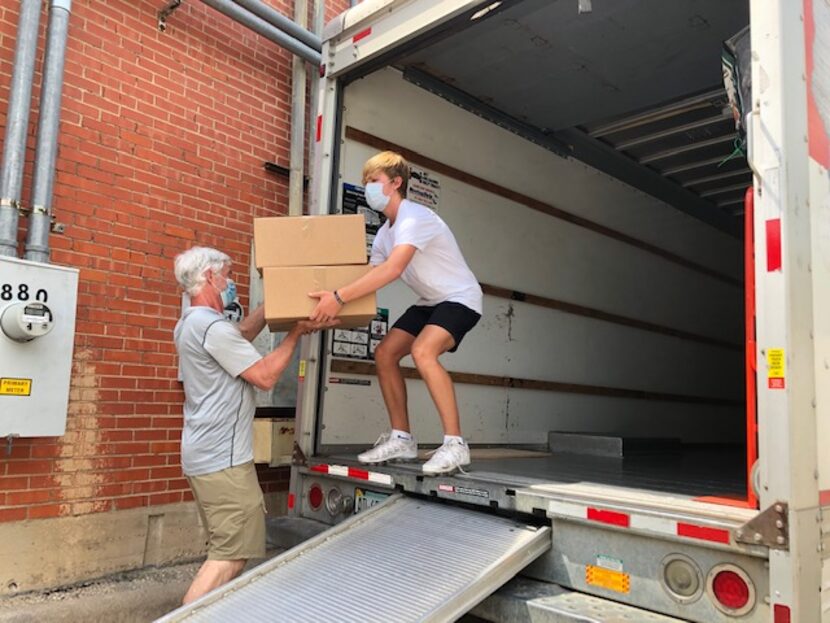 Volunteers for Summer Santa load 406 toy boxes for 406 North Texas children who can't go to...