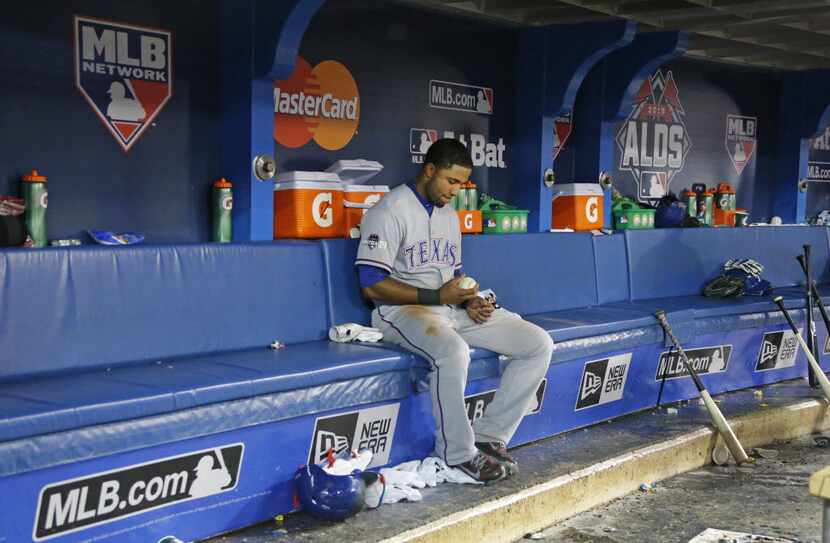 Texas Rangers shortstop Elvis Andrus (1) sits alone in the dugout after the final out in the...
