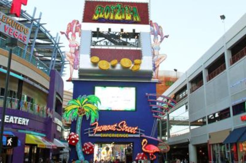 
In this April 27, 2014 photo provided by the Fremont Street Experience, guests ride zip...