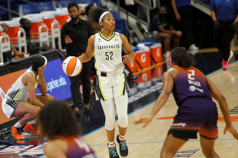Dallas Wings guard Tyasha Harris (52) looks to pass as she sets up an offensive play during...