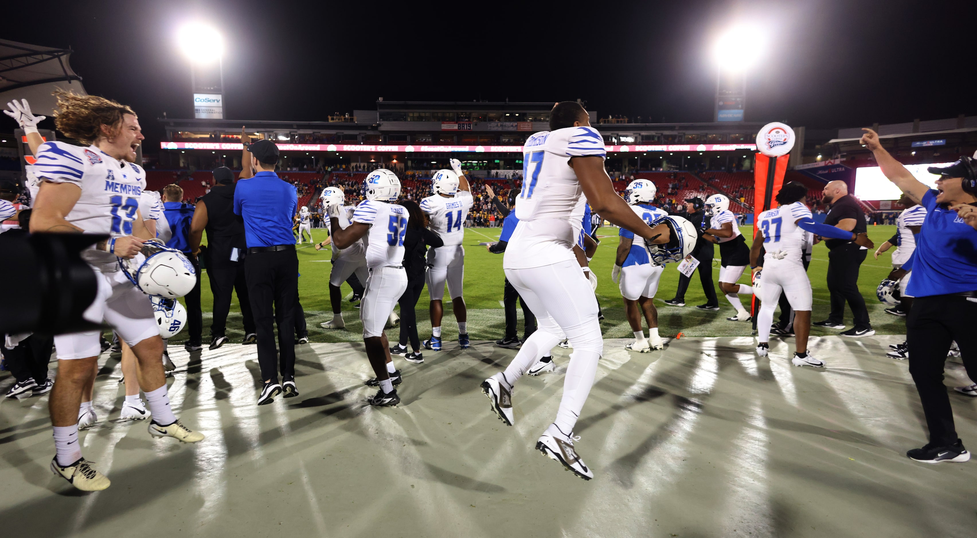 Memphis players erupt in the team bench area during the final seconds of the Tigers' 42-37...