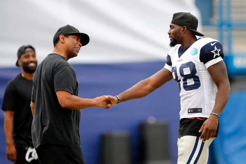 Dallas Cowboys fan and actor Denzel Washington (right) meets with Dallas Cowboys wide...