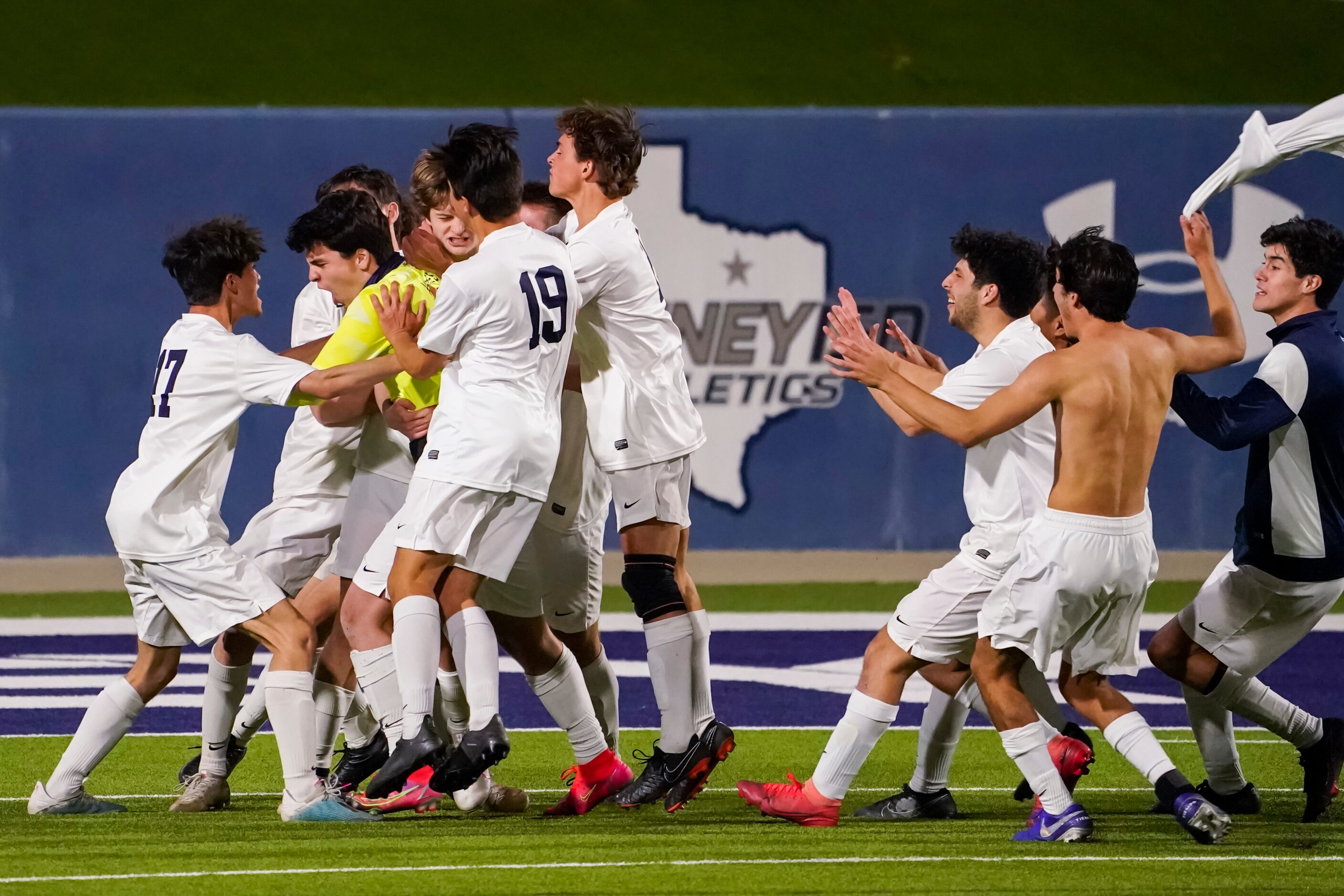 Jesuit teammates mob midfielder Sullivan Scott and goalkeeper Cole Hines after Scott’s goal...