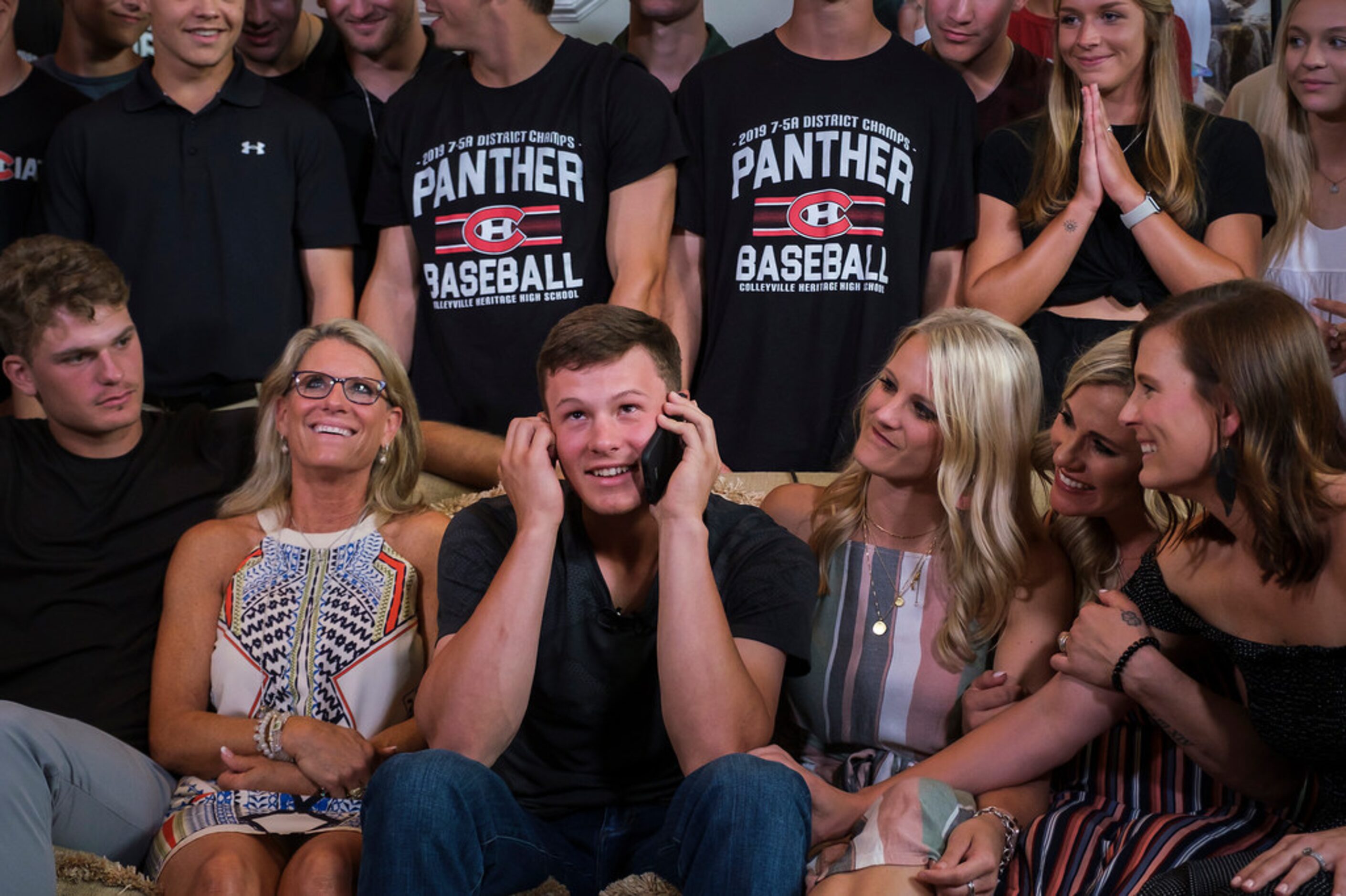 Bobby Witt Jr. takes a phone call immediately after the first pick was announced during a...