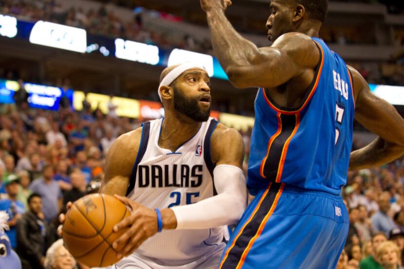 Vince Carter (25) of the Dallas Mavericks looks to pass the ball against the Oklahoma City...