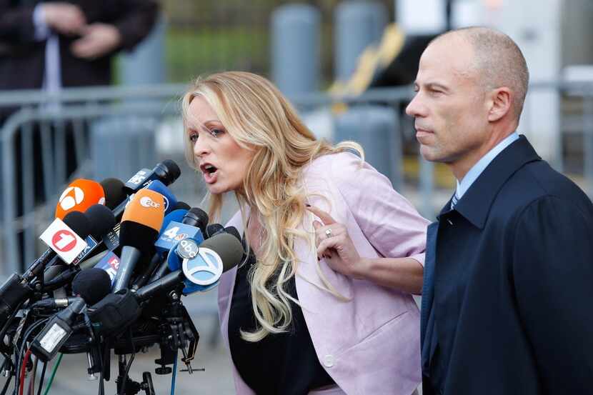Porn actress Stormy Daniels (shown with her attorney, Michael Avenatti) and her husband,...