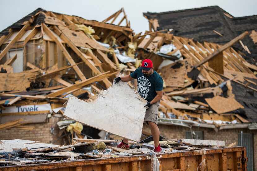 Member Jose Posada helps to clean up what remains of Primera Iglesia Bautista Mexicana on...