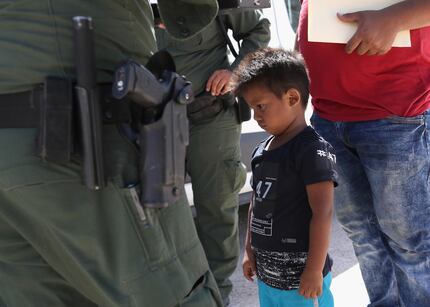 MISSION, TX - JUNE 12:  A boy and father from Honduras are taken into custody by U.S. Border...