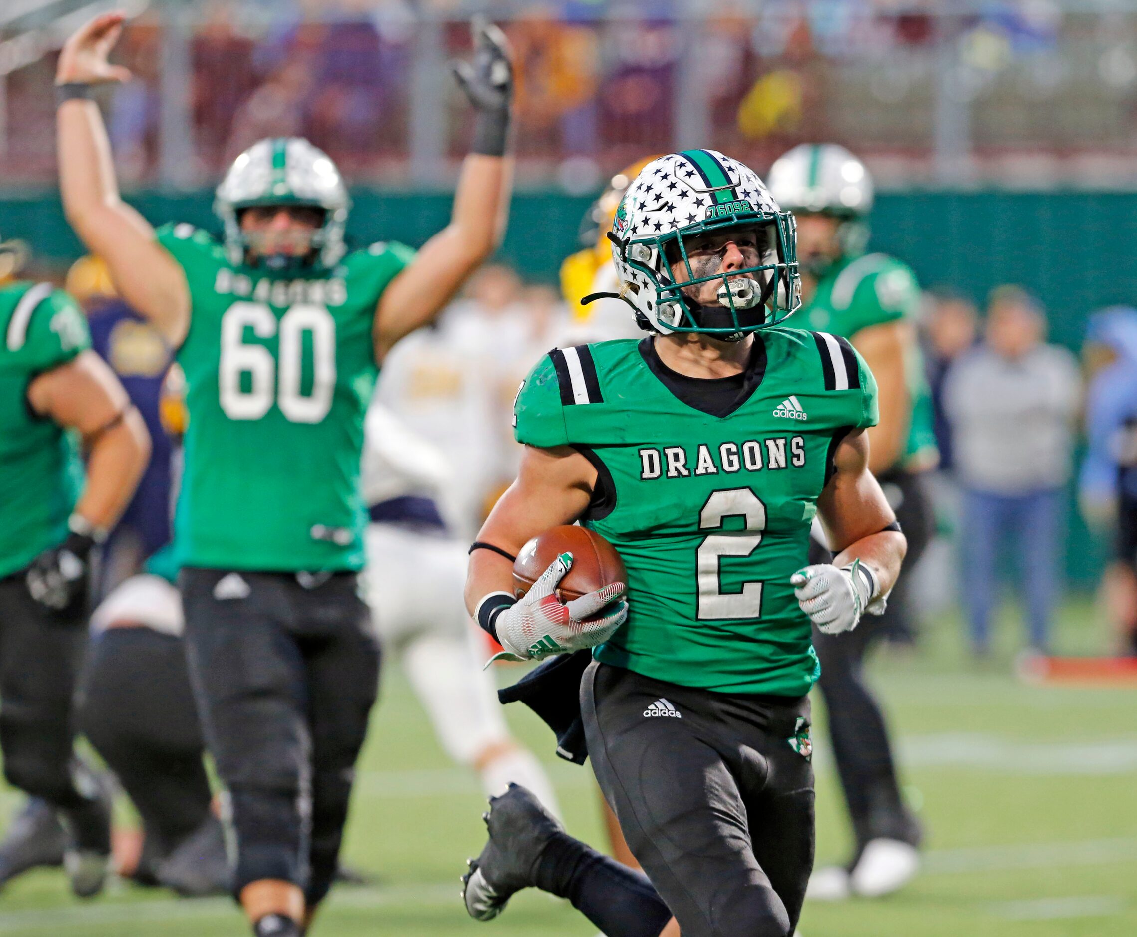 Southlake RN Owen Allen (2) scores a touchdown, as teammate Jackson Underwood (60) signals...