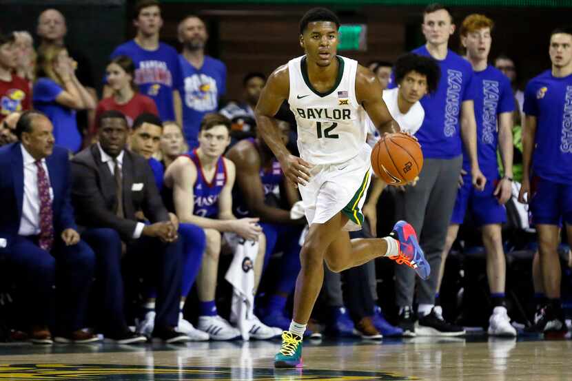 FILE - Baylor guard Jared Butler dribbles up court against Kansas during an NCAA college...