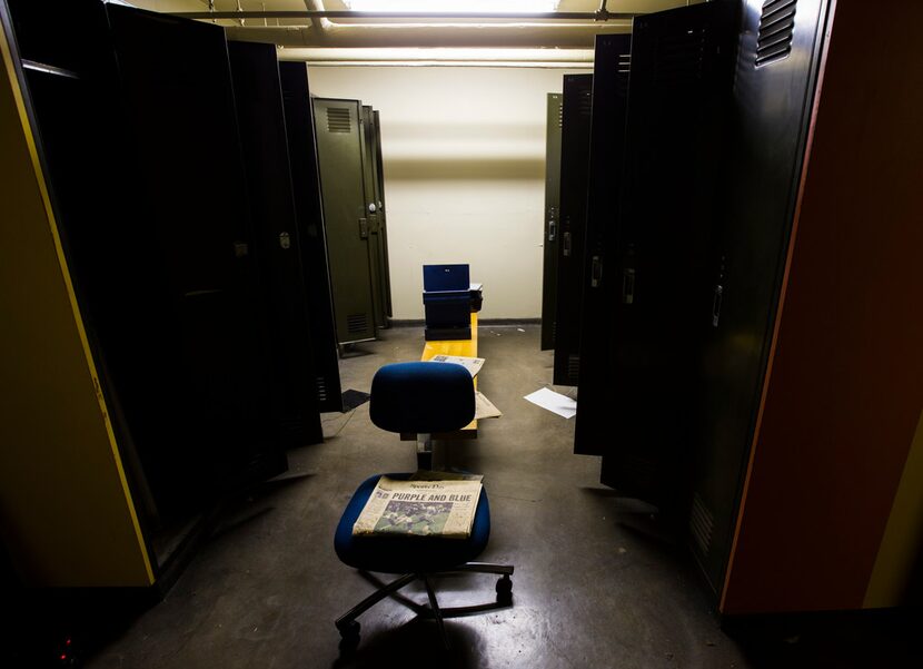 A newspaper from 1999 rests on an office chair in the old locker rooms that were once used...