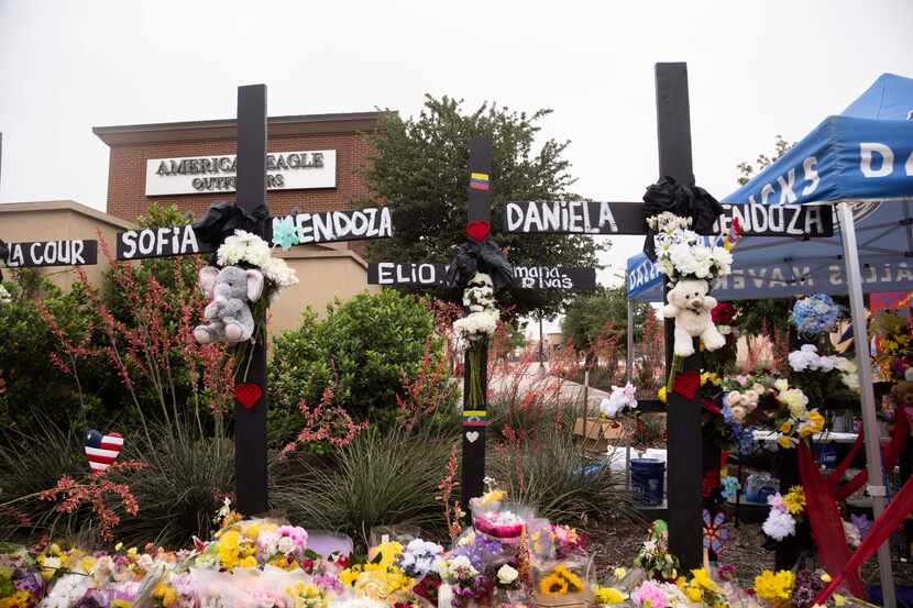 Crosses with the names of Sofia Mendoza, Elio Cumana-Rivas and Daniela Mendoza, who were...