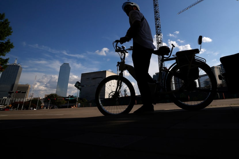 Hexel Colorado, who lives in downtown Dallas without a car, leaves a grocery store, Friday,...