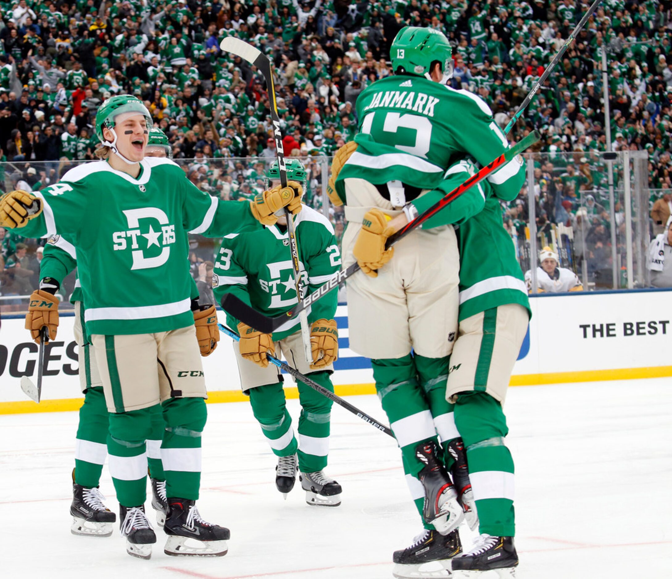 Dallas Stars center Mattias Janmark (13) jumps into the arms of defenseman John Klingberg...