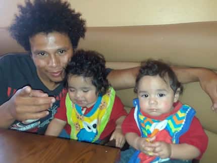 Nestor Martinez poses with his twin sons Elijah and Josiah. They, along with Nestor...