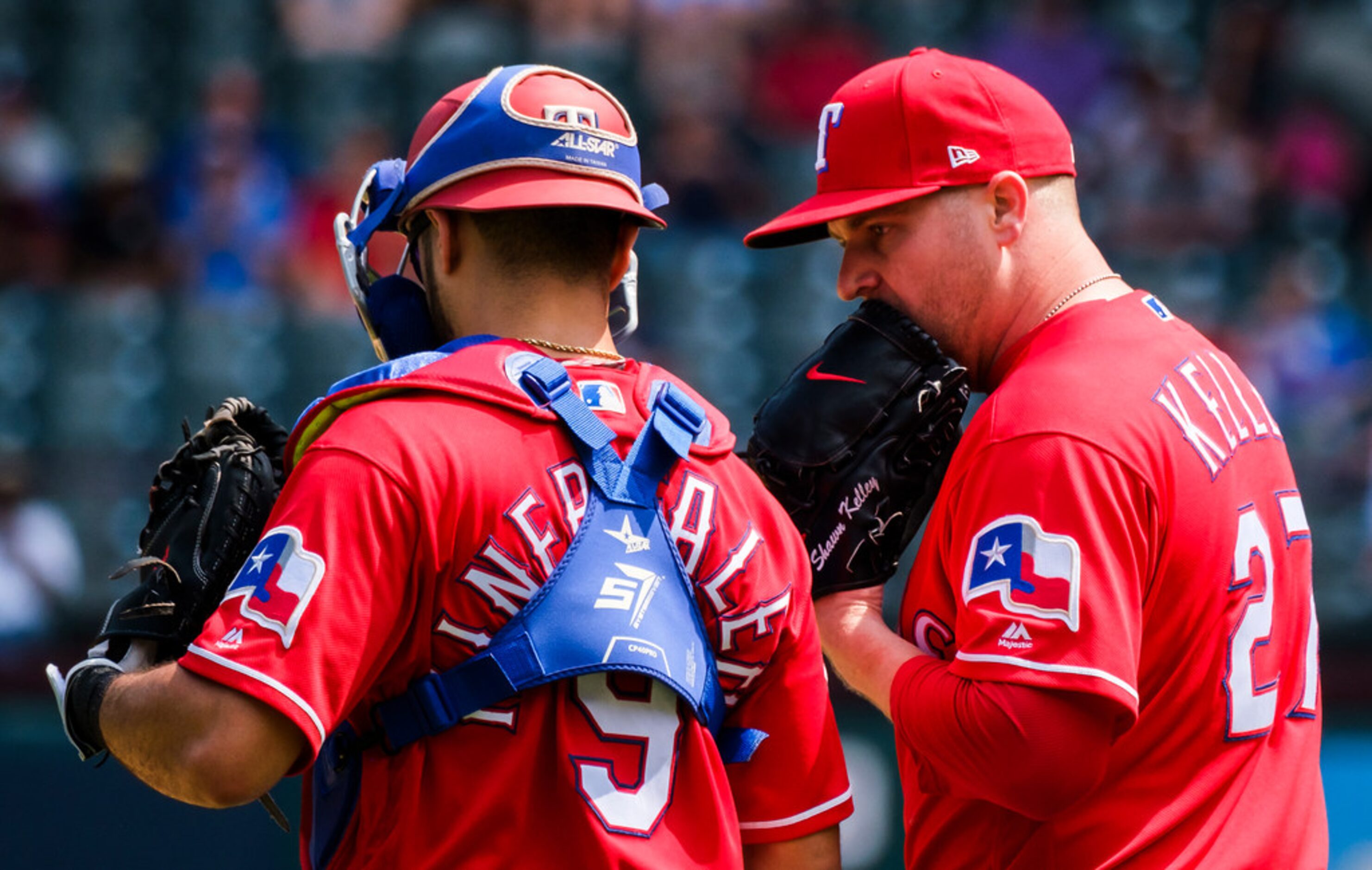 Texas Rangers pitcher Shawn Kelley gets a visit from catcher Isiah Kiner-Falefa during the...