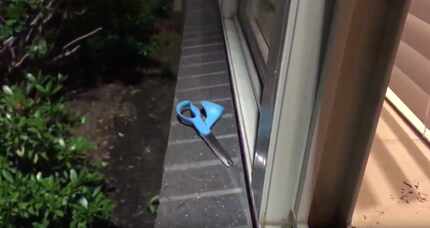 A pair of scissors lies outside an apartment where a naked man broke in through a window and...