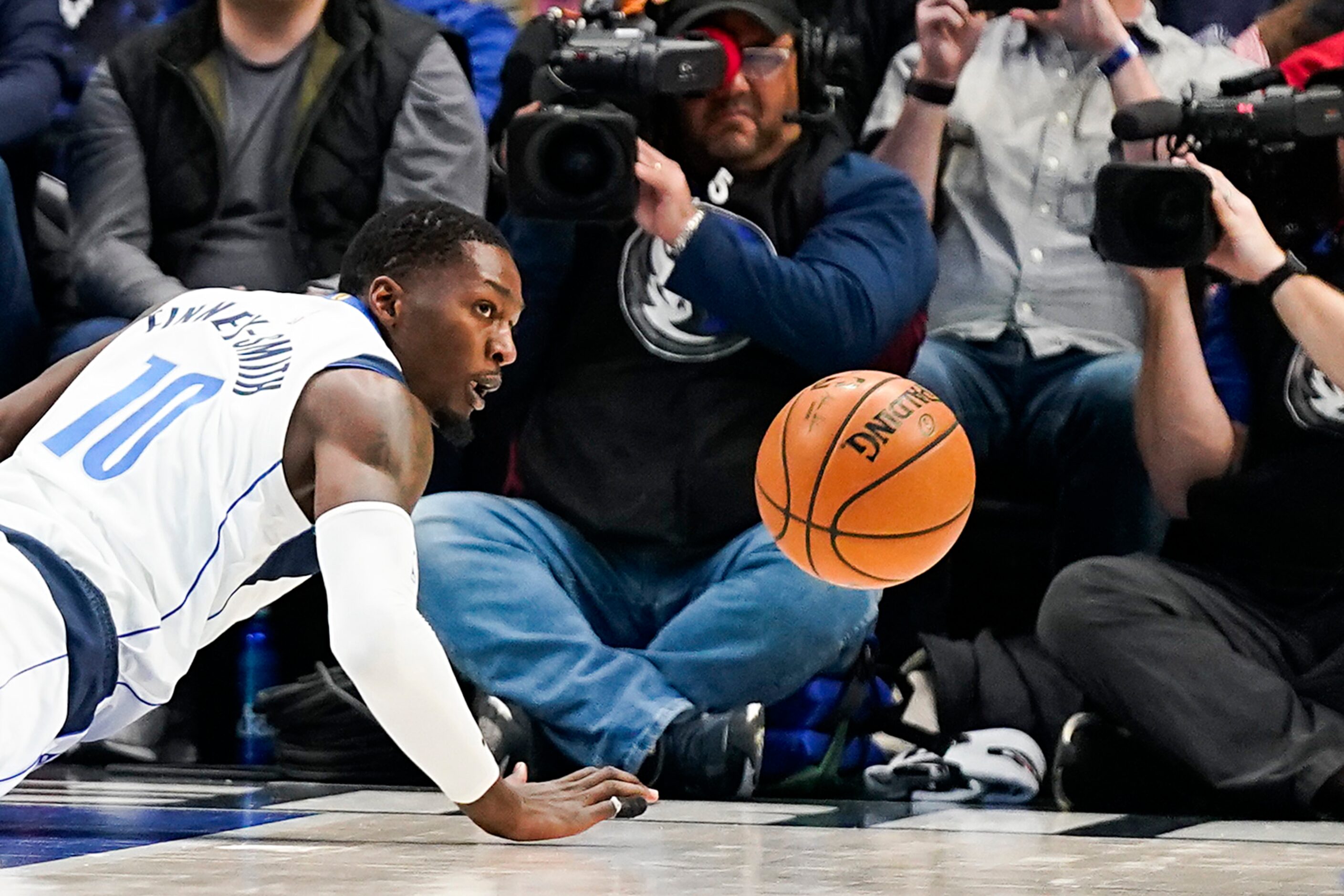 Dallas Mavericks forward Dorian Finney-Smith dives for a loose ball during the first half of...