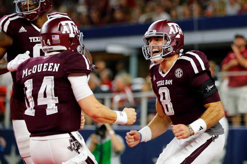 Trevor Knight (8) and teammate Conner McQueen celebrated the first of two long touchdown...