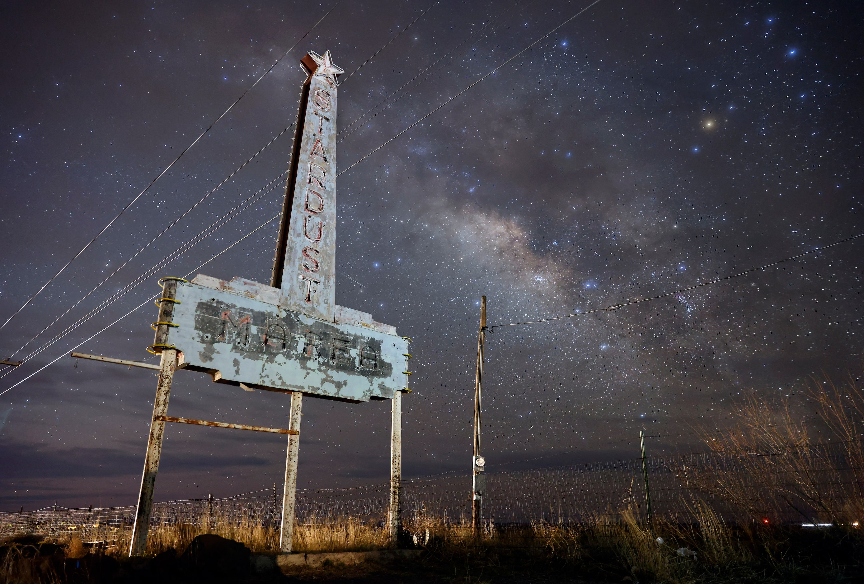 The Milky Way galaxy rises behind the old Stardust Motel sign outside Marfa, Texas, March...