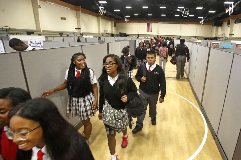  Students walk the 'hallway' between classes Thursday at Triple A Academy. They'll move to a...