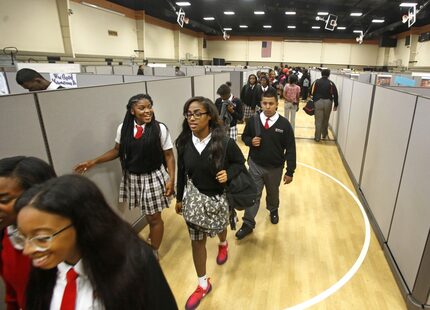  Students walk the 'hallway' between classes Thursday at Triple A Academy. They'll move to a...