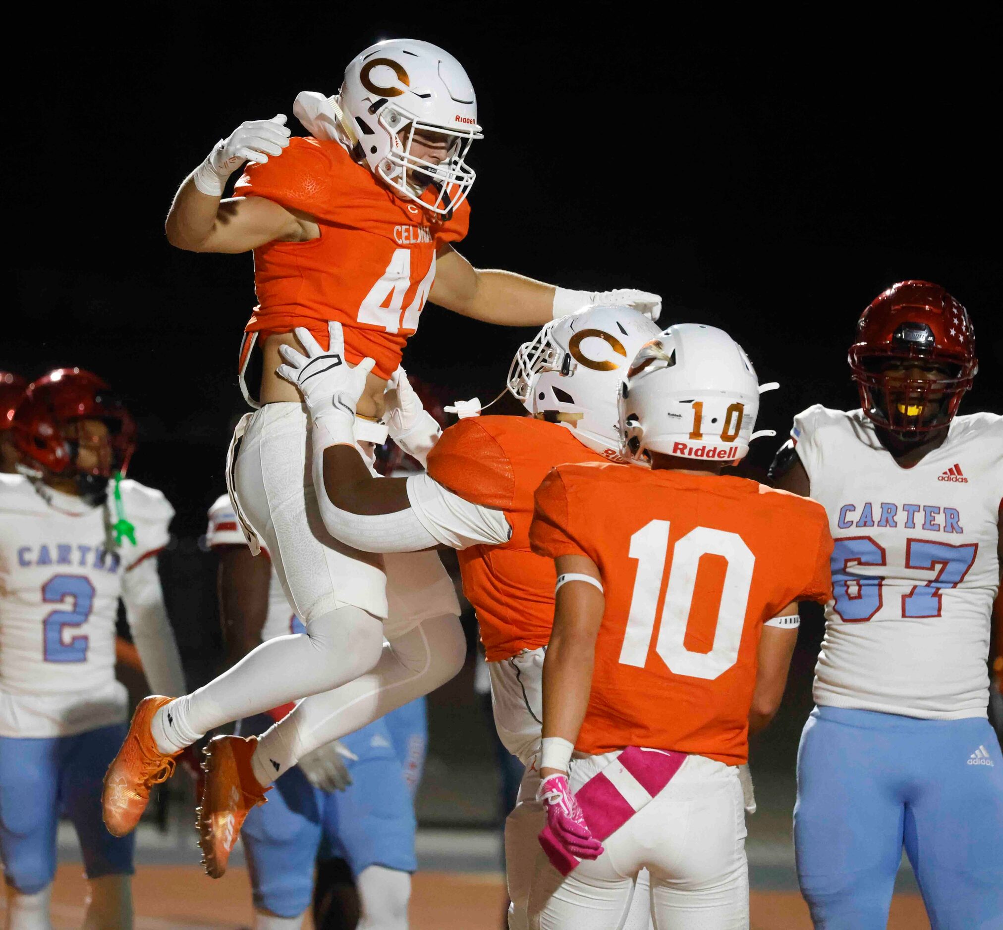 Celina High School’s Caden Mitchell (44) celebrates a touchdown against David W. Carter High...