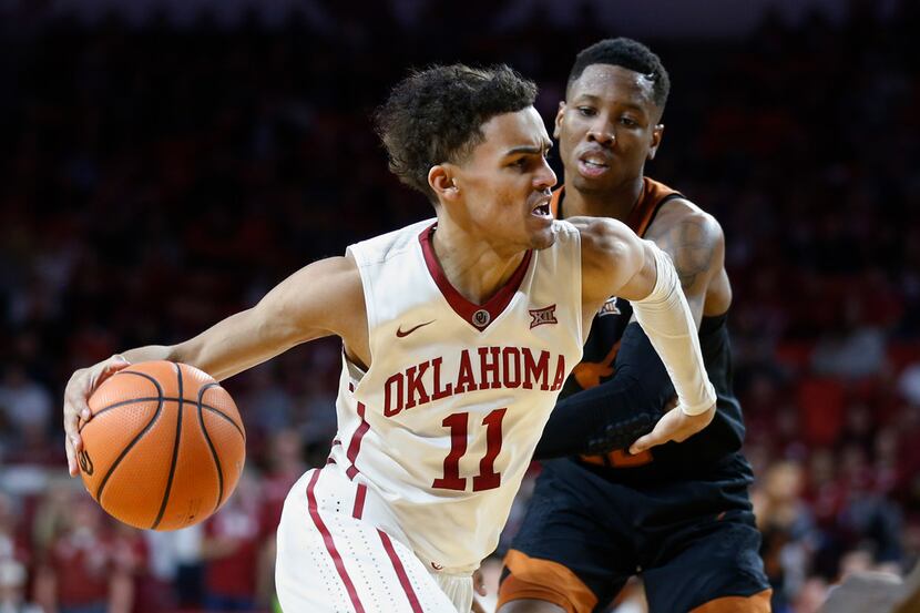 Oklahoma guard Trae Young (11) drives past Texas guard Kerwin Roach II, right, in the second...