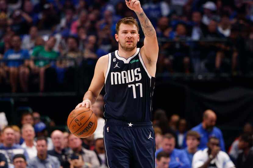 Dallas Mavericks guard Luka Doncic (77) signals to a teammate during the first half of the...