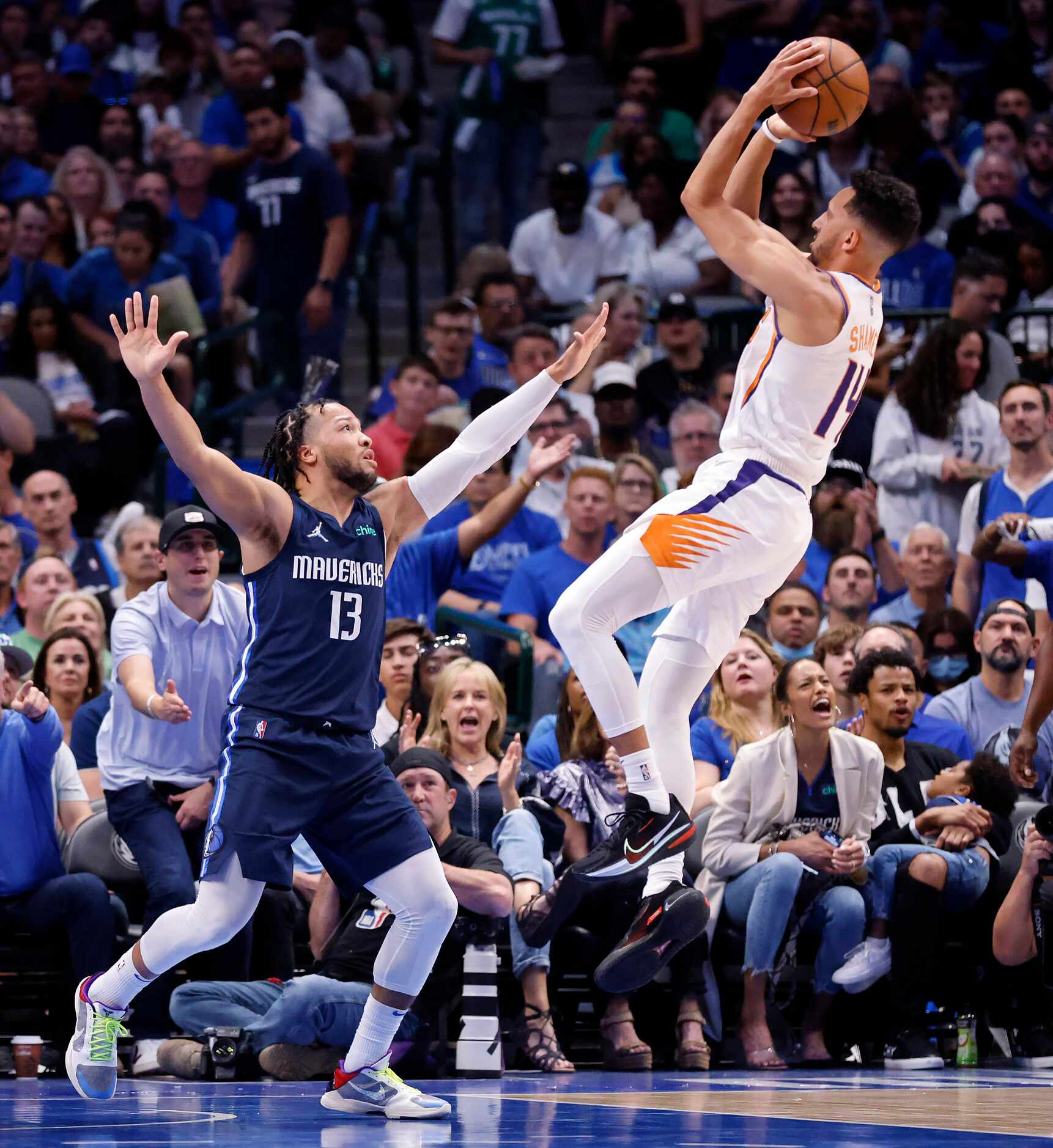 Phoenix Suns guard Landry Shamet (14) puts up a step back shot over Dallas Mavericks guard...