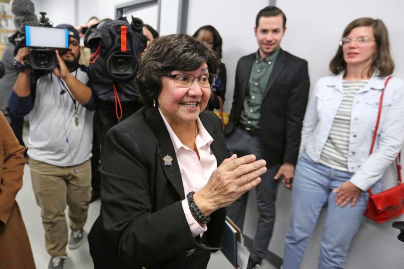 Recently resigned Dallas County Sheriff Lupe Valdez makes her way through the media to head...