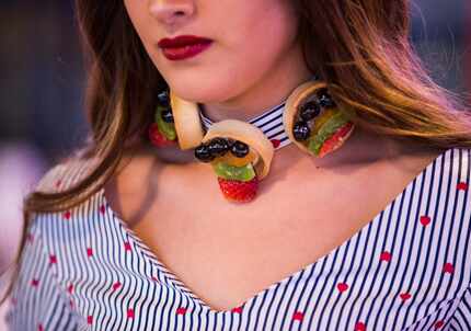 Model Aneida Gonzalez wears a choker decorated with fruit tarts from La Madeleine at Food in...