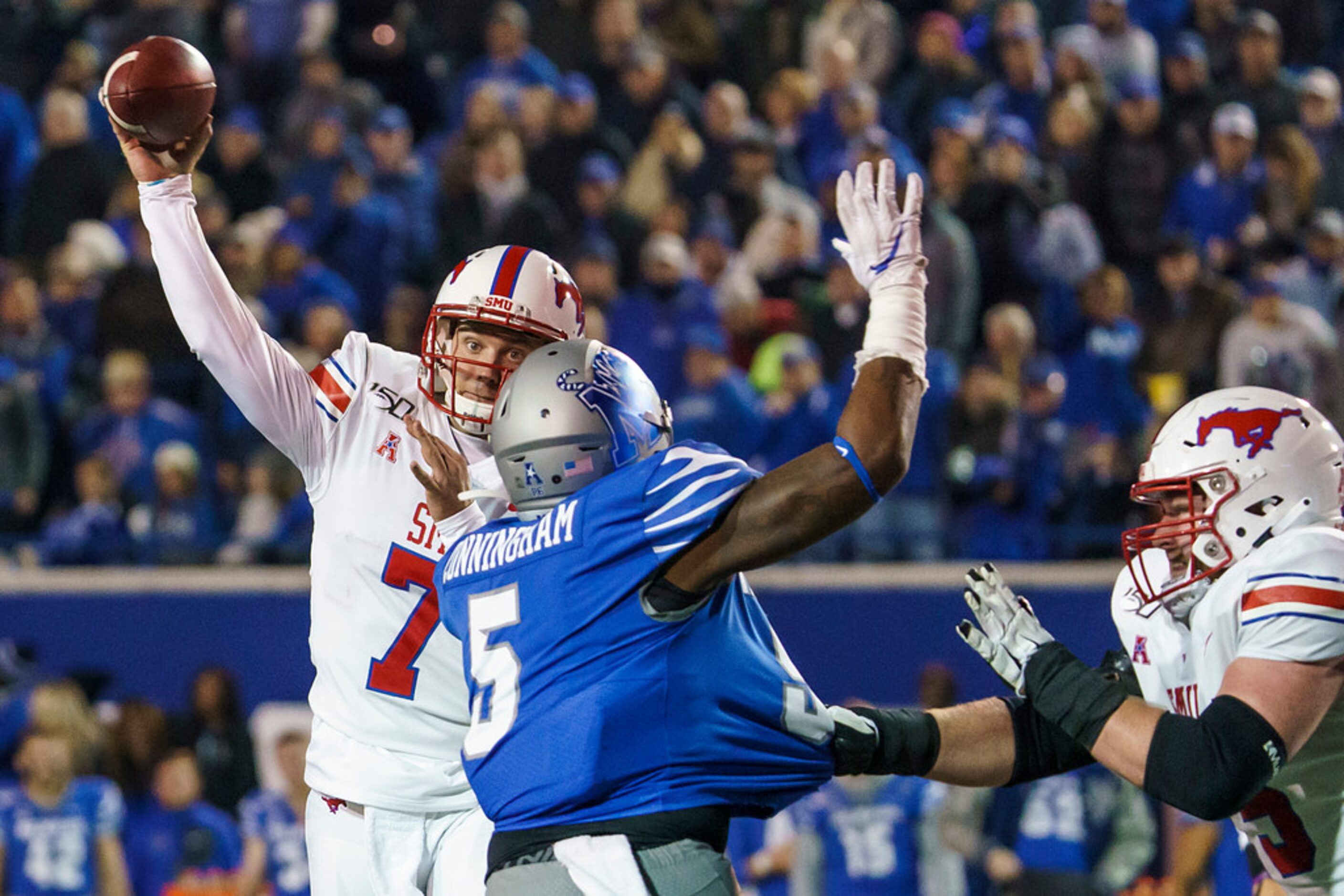 SMU quarterback Shane Buechele (7) gets off a pass under pressure from Memphis defensive end...