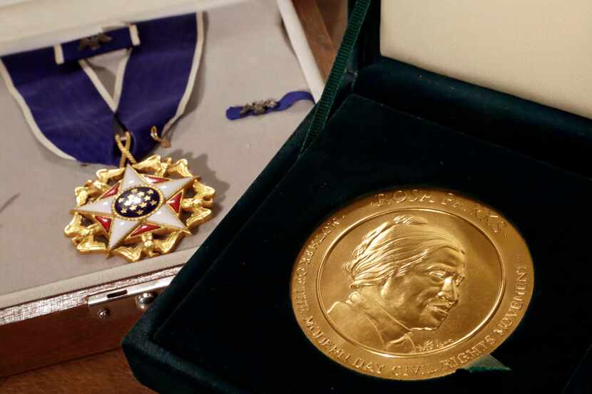 FILE - In this March 14, 2014, file photo, Rosa Parks' Presidential Medal of Freedom, left,...