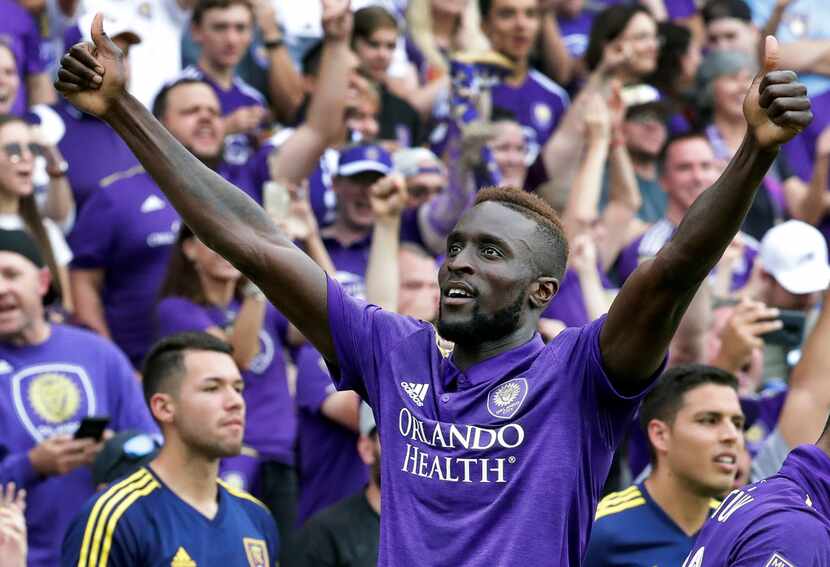 Orlando City's Lamine Sane gives the thumbs-up to fans after scoring a goal against Real...
