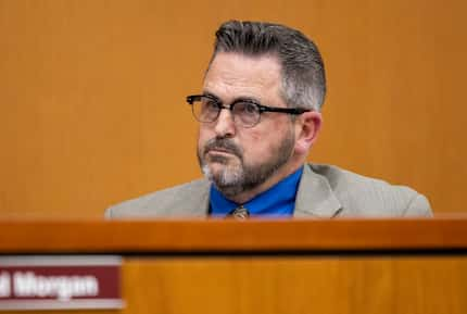 Superintendent Tyson Bennett listens to public comment during a school board meeting at the...