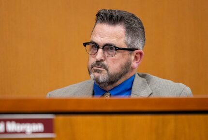 Superintendent Tyson Bennett listens to public comment during a school board meeting at the...