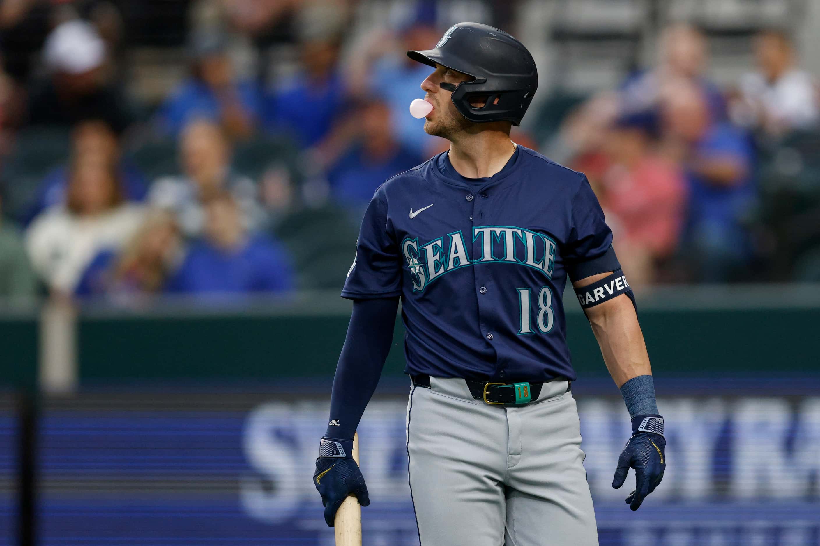 Seattle Mariners designated hitter Mitch Garver (18) walks to the dugout after striking out...