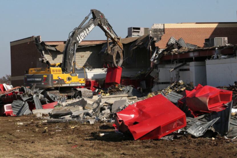 Construction workers begin the task of demolishing West High School Thursday. The building...