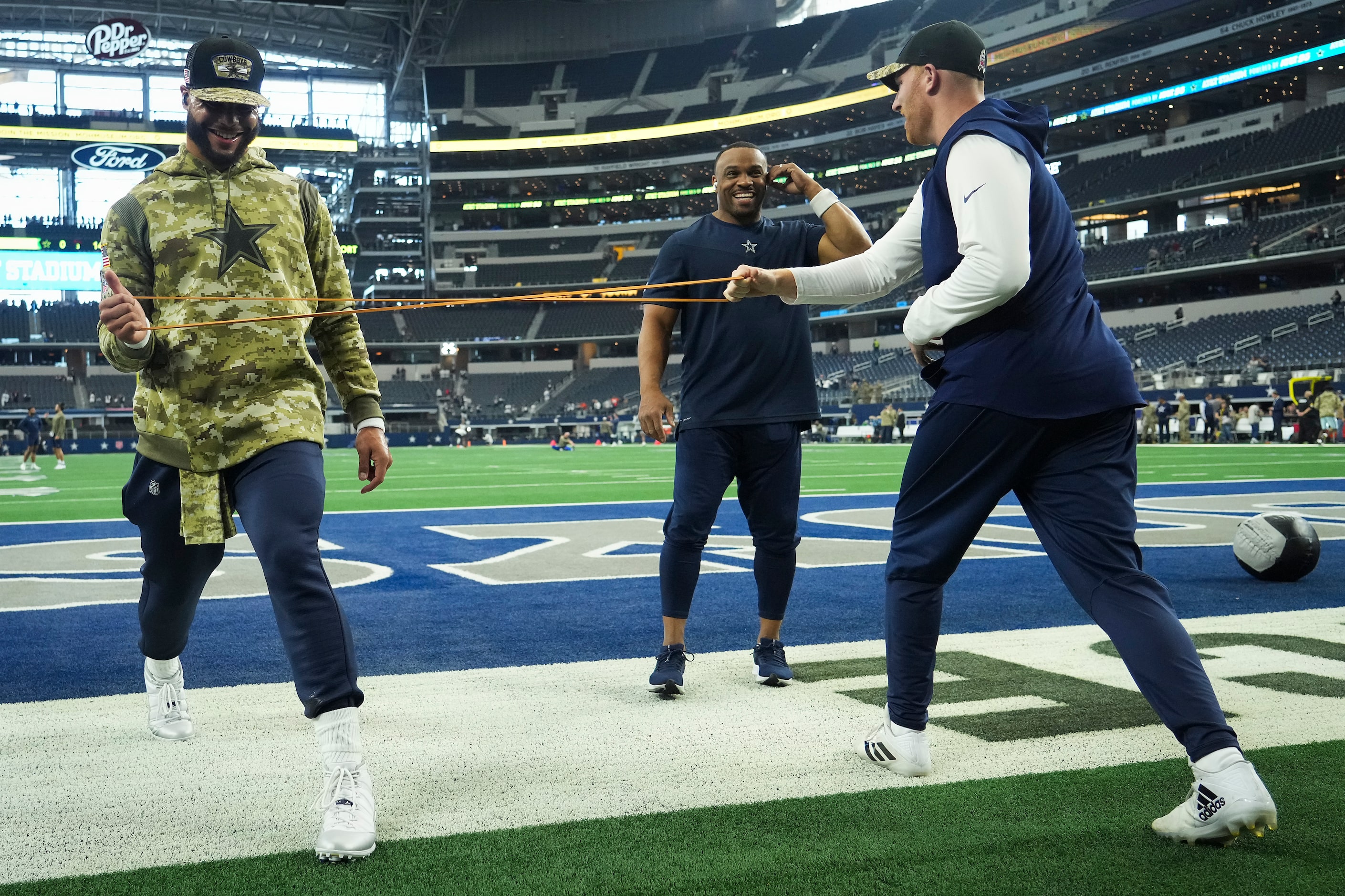 Dallas Cowboys quarterback Dak Prescott (left) and quarterback Cooper Rush stretch before an...