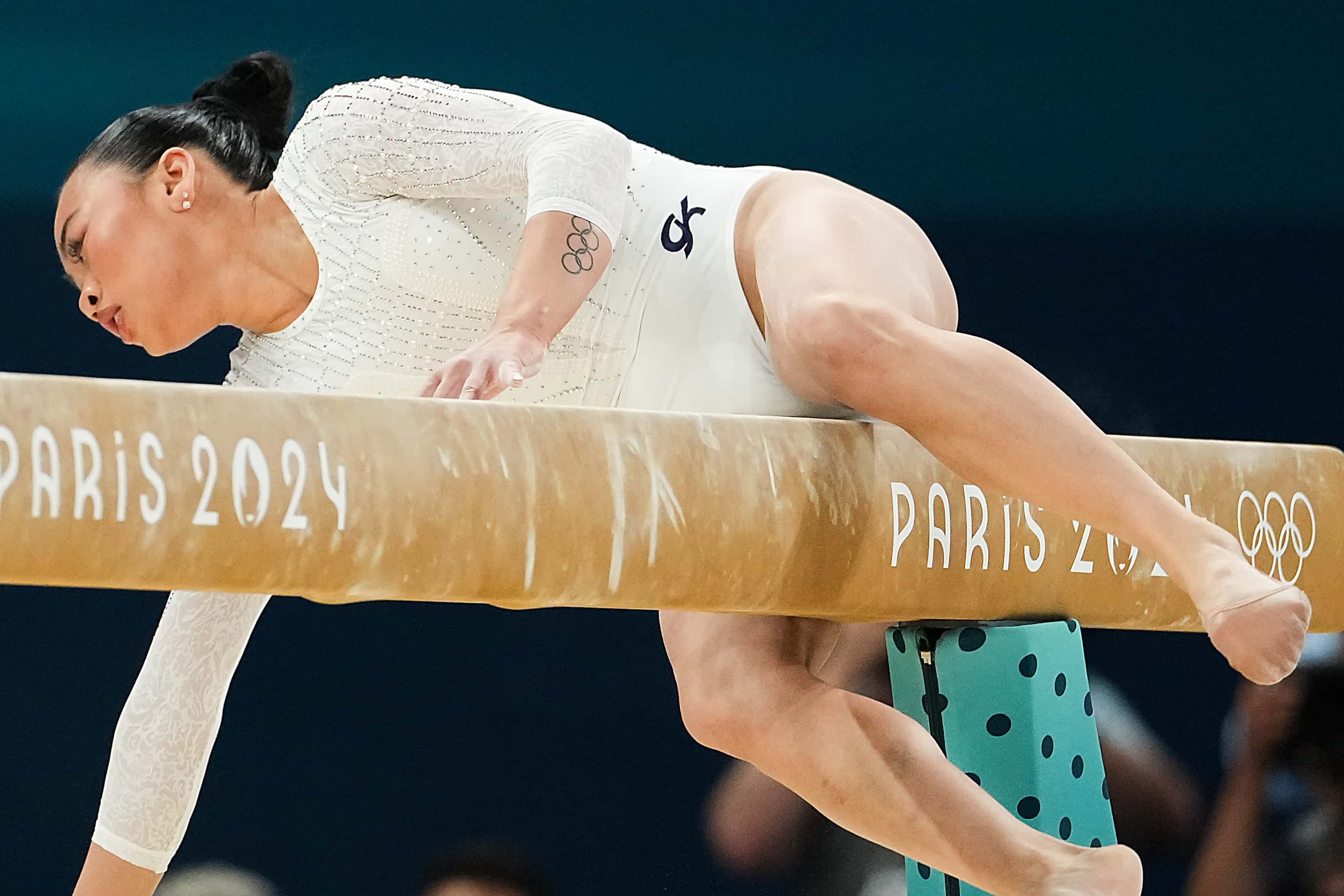Suni Lee of the United States falls while competing on the balance beam during the women’s...