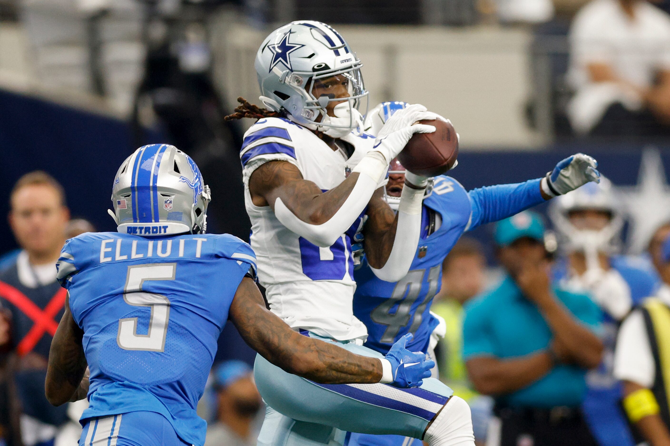 Dallas Cowboys wide receiver CeeDee Lamb (88) makes a catch between Detroit Lions safety...