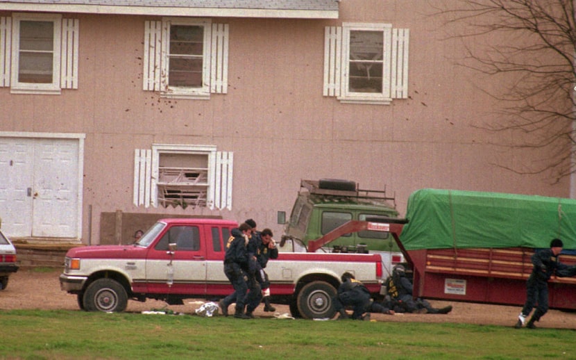 Federal Alcohol Tobacco and Firearms agents help a wounded fellow agent away from the...