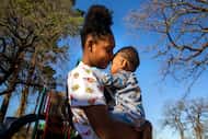 Adrianna Smith, from Pleasant Grove, embraces her 19-month-old child, LaRey, while visiting...